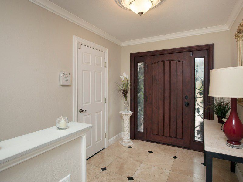Traditional Entryway with Standard height, six panel door, flush light, Crown molding, travertine tile floors, specialty door