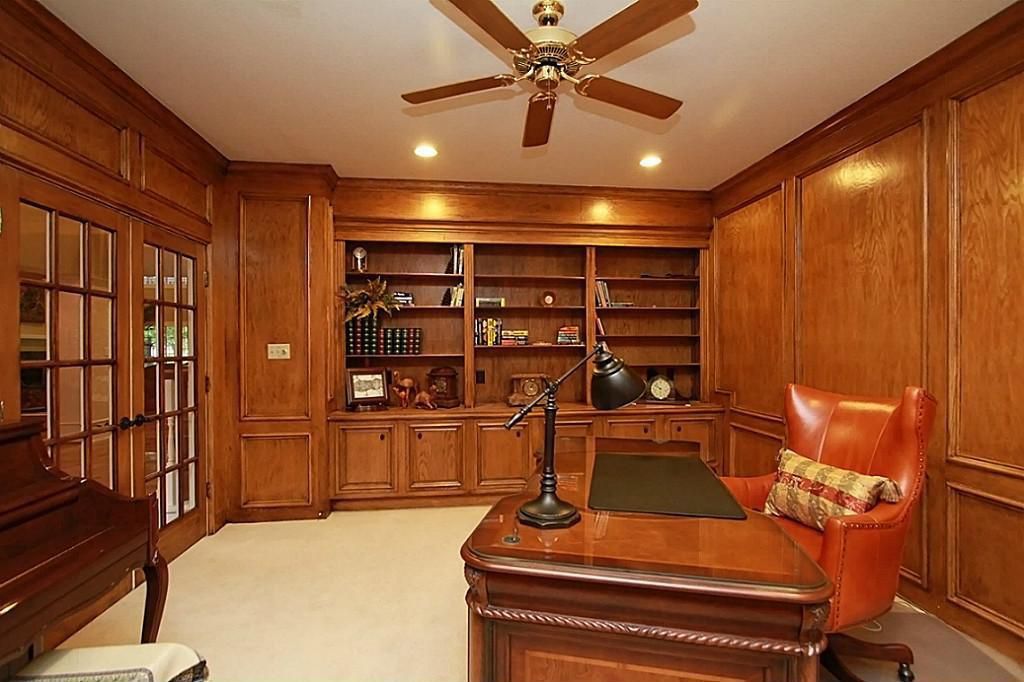 Traditional Home Office with Crown molding, Carpet, can lights, Built-in bookshelf, Standard height, French doors