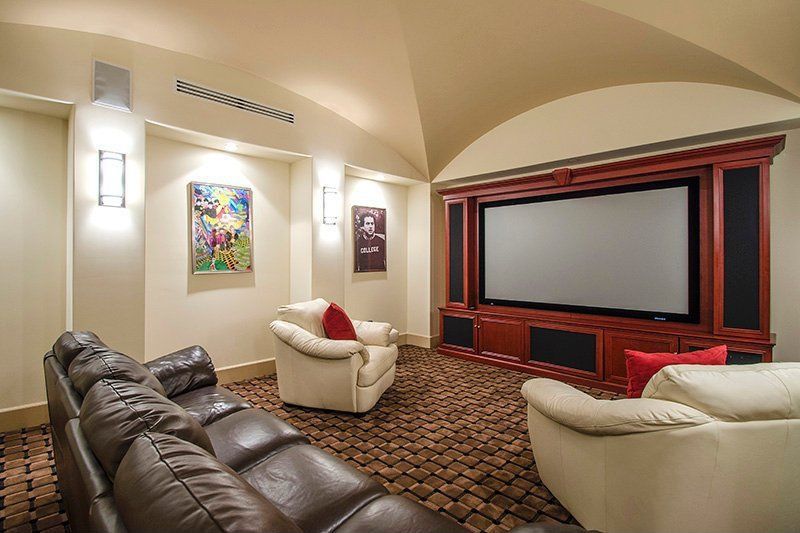 Mediterranean Home Theater with Wall sconce, can lights, High ceiling, Carpet, Built-in bookshelf