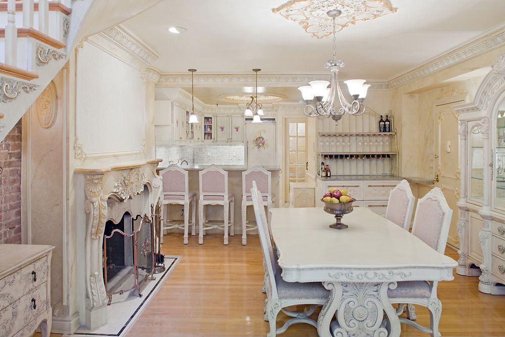 Traditional Dining Room with six panel door, Chandelier, Laminate floors, Fireplace, metal fireplace, Crown molding