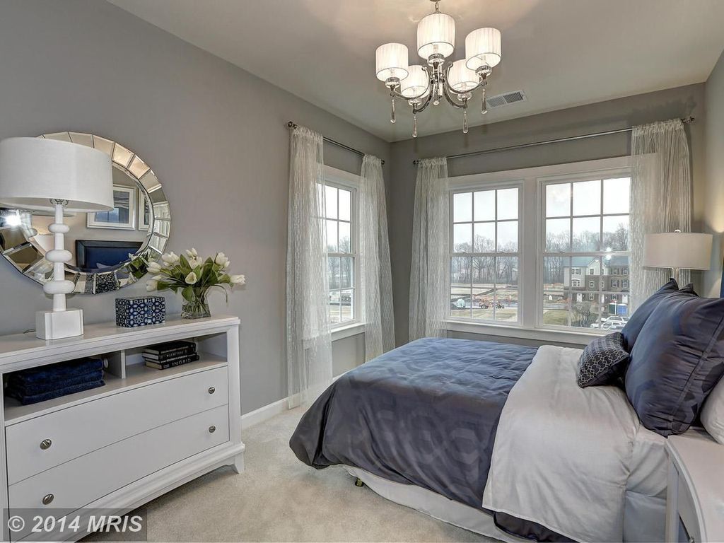 Traditional Guest Bedroom with double-hung window, Chandelier, Standard height, Carpet