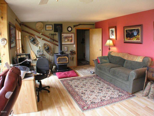 Craftsman Living Room with flat door, Standard height, Wood Stove fireplace, Hardwood floors, Fireplace, Ceiling fan
