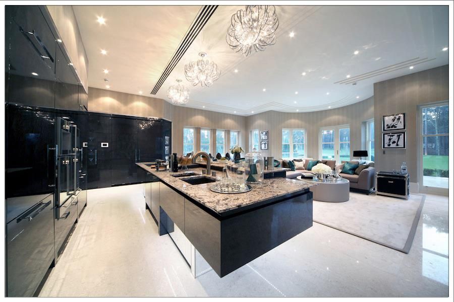 Contemporary Kitchen with Flush, L-shaped, European Cabinets, double wall oven, Built In Panel Ready Refrigerator, can lights