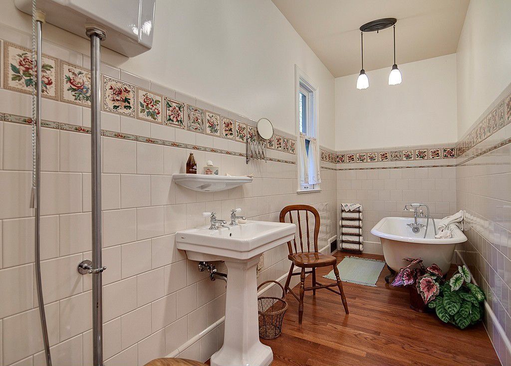 Country Full Bathroom with Full Bath, double-hung window, Bathtub, Hardwood floors, Standard height, Wall Tiles, Clawfoot