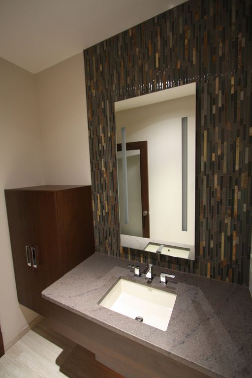 Contemporary Powder Room with Flush, stone tile floors, Simple granite counters, Standard height, full backsplash