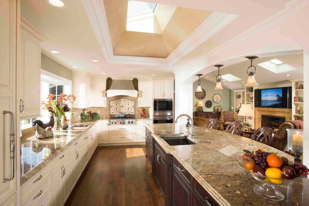Traditional Kitchen with Crown molding, Skylight, Undermount sink, Large Ceramic Tile, can lights, full backsplash, L-shaped