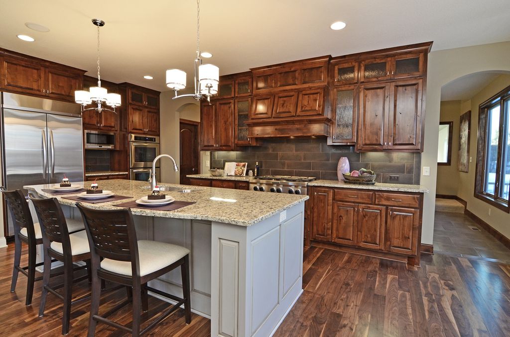 Contemporary Kitchen with Simple granite counters, Glass panel, Kitchen island, electric cooktop, Pendant light, L-shaped