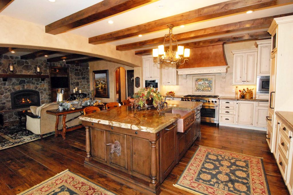 Country Kitchen with L-shaped, Standard height, Exposed beam, Limestone, wall oven, full backsplash, Flush, Breakfast bar