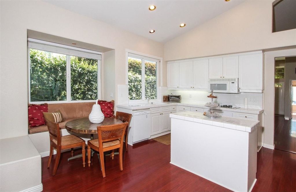 Traditional Kitchen with Laminate floors, Paint 1, Undermount sink, Breakfast nook, wall oven, can lights, Large Ceramic Tile