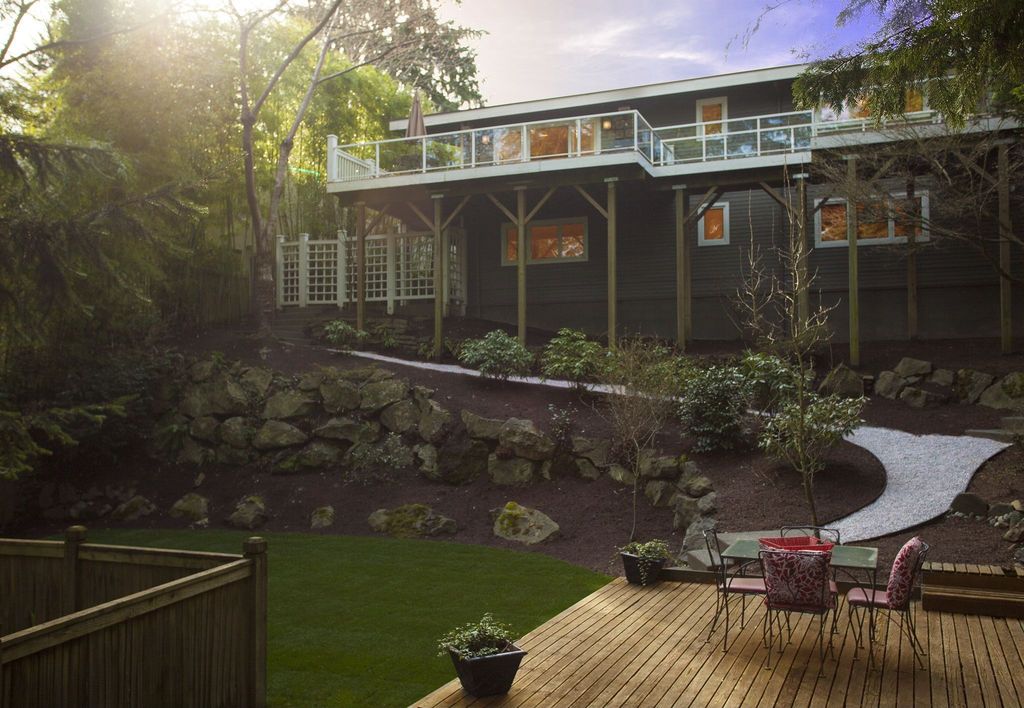 Traditional Landscape/Yard with Deck Railing, Raised beds, Fence, Pathway, picture window