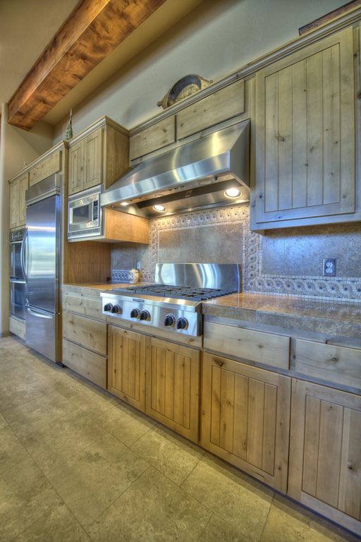 Eclectic Kitchen with Standard height, Flush, electric cooktop, Simple Granite, One-wall, double wall oven, Exposed beam