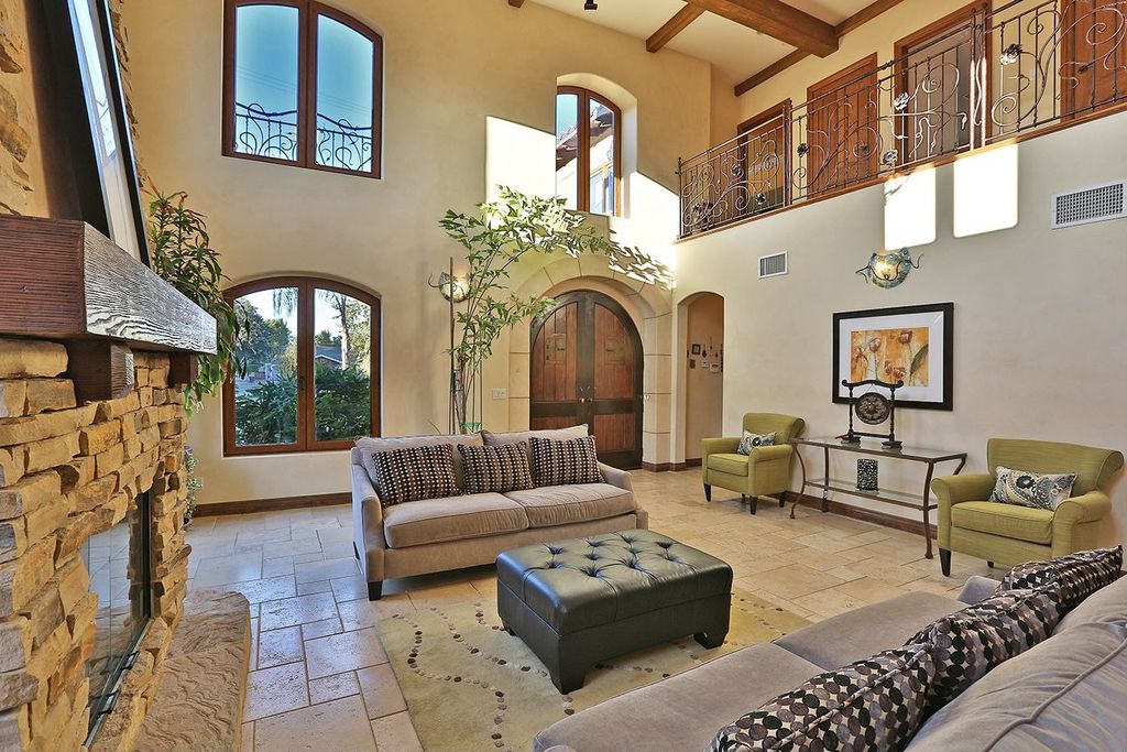 Craftsman Living Room with Balcony, Exposed beam, High ceiling, French doors, Casement, Fireplace, stone fireplace