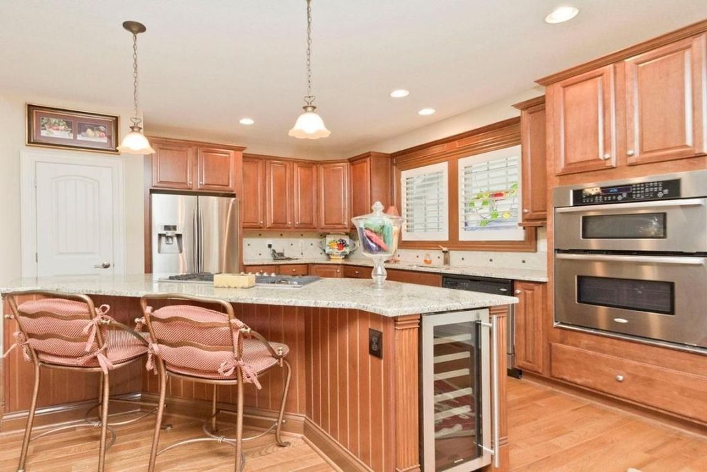 Craftsman Kitchen with Standard height, Built In Refrigerator, Simple granite counters, Wine refrigerator, specialty door