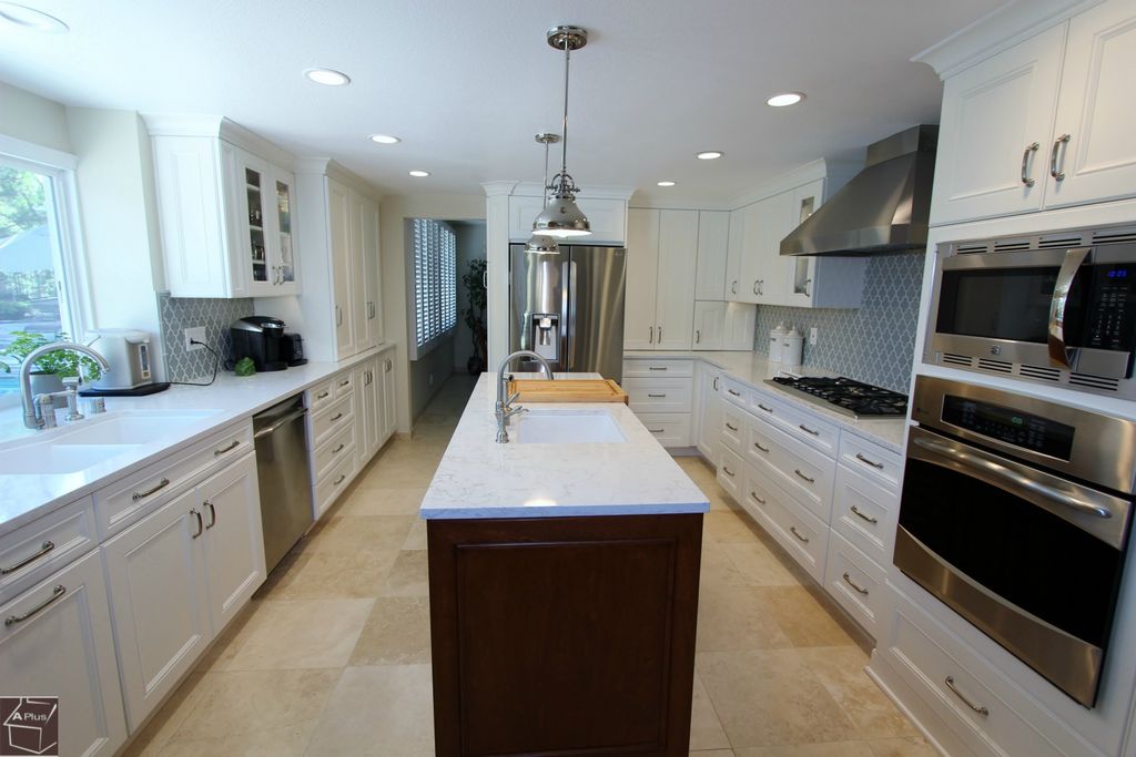 Contemporary Kitchen with Flat panel cabinets, full backsplash, Glass panel, built-in microwave, Standard height, Wall Hood