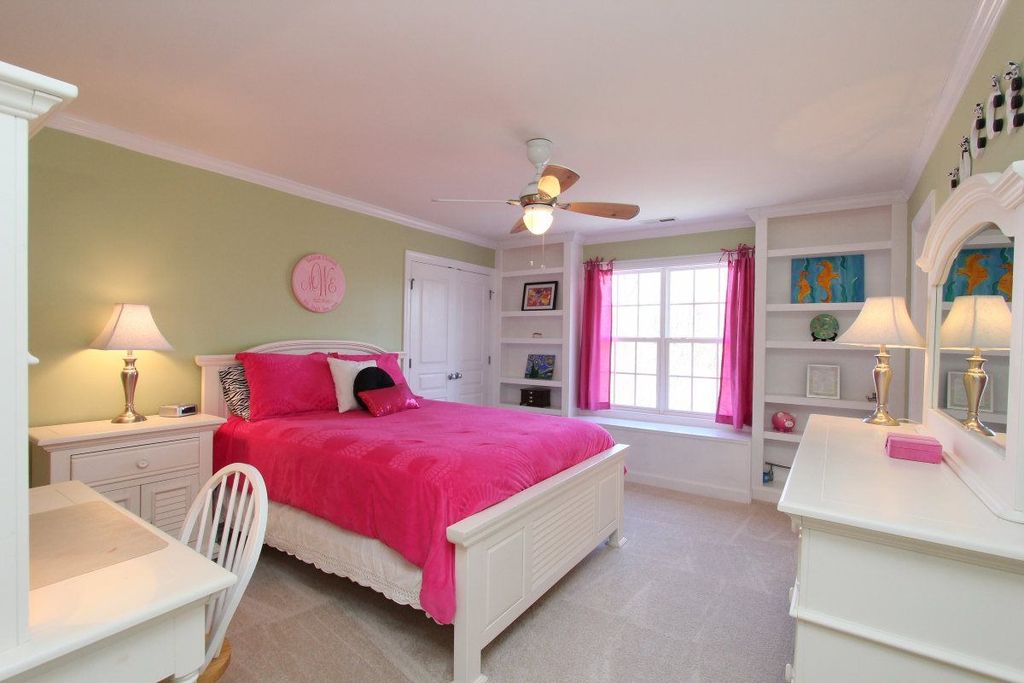 Traditional Kids Bedroom with Crown molding, Carpet, Standard height, double-hung window, Ceiling fan, Built-in bookshelf