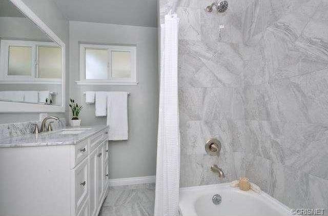 Traditional Full Bathroom with Flat panel cabinets, Standard height, stone tile floors, drop in bathtub, Casement, Bathtub