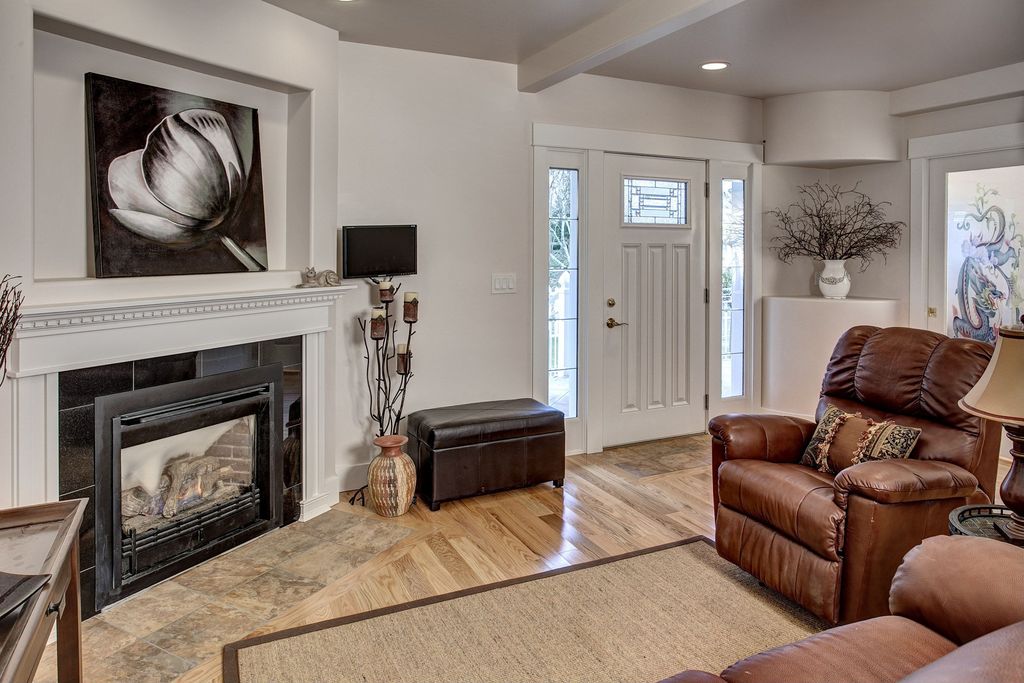 Traditional Living Room with Standard height, Glass panel door, Exposed beam, can lights, Hardwood floors, French doors