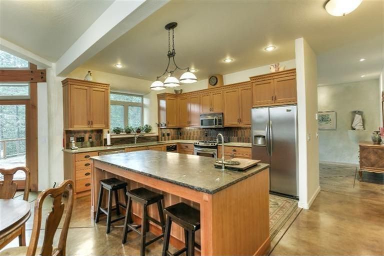 Craftsman Kitchen with Built In Refrigerator, Pottery barn - tibetan barstool mahogany, L-shaped, Stone Tile, Concrete tile