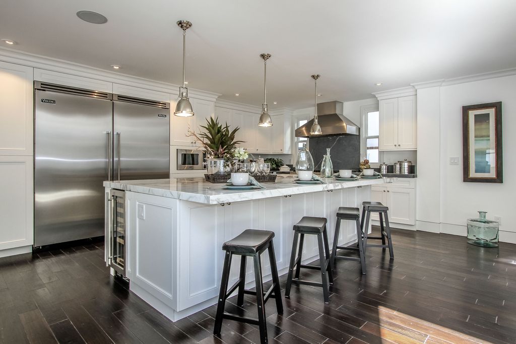 Traditional Kitchen with Soapstone, Pendant light, partial backsplash, Flush, Wall Hood, Built In Refrigerator, Crown molding