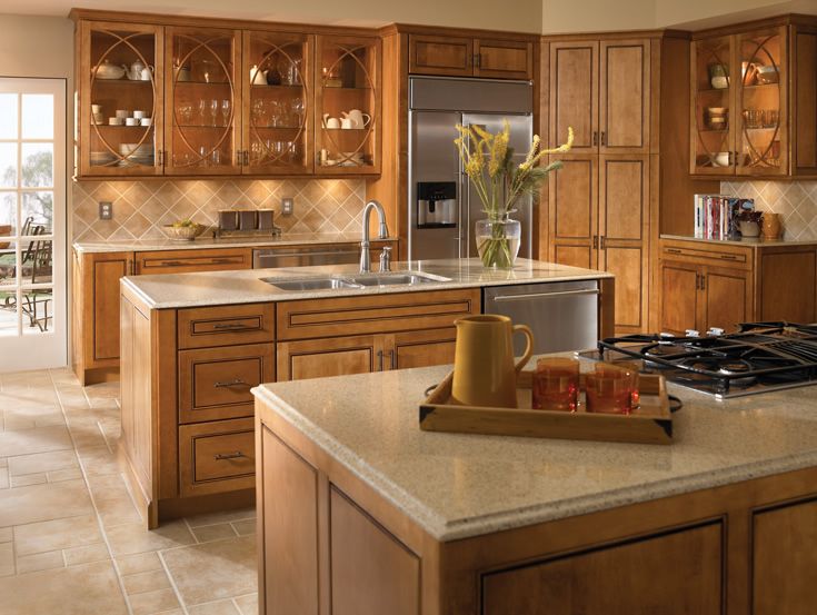 Craftsman Kitchen with Kitchen island, full backsplash, Simple granite counters, Built In Refrigerator, Glass panel, L-shaped