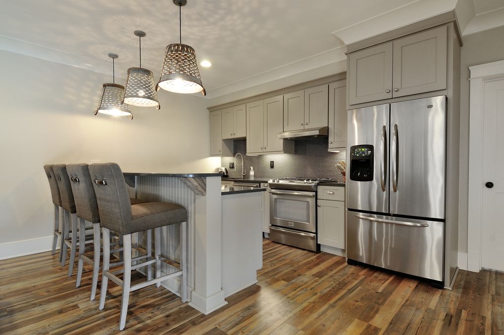 Modern Kitchen with Flat panel cabinets, Standard height, Framed Partial Panel, Penny Tile, full backsplash, Breakfast bar